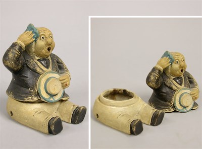 Lot 992 - Weller Pottery Figural Box of a Man The seated...