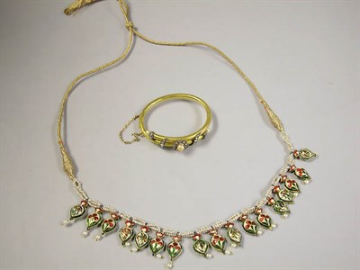 Lot 541 - Gold and Diamond Bangle Bracelet and Indian Cord Necklace