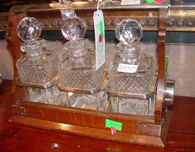 Lot 1507 - English Oak Tantalus with Three Glass...