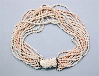 Lot 635 - Twelve Strand Coral Bead Torsade Necklace