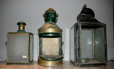 Lot 1128 - Three Metal Lanterns Height of tallest 23 inches.