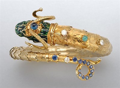 Lot 1454 - Gold, Enamel, Sapphire, Synthetic Sapphire, Emerald and Diamond Ram's Head Bangle