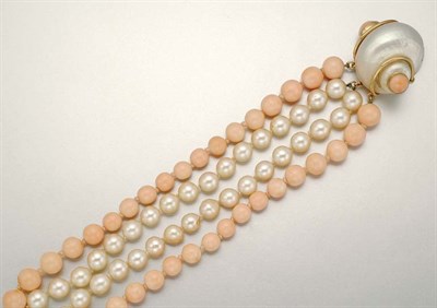 Lot 1033 - Four Strand Cultured Pearl and Coral Bead Torsade Bracelet with Shell and Coral Clasp