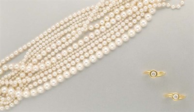 Lot 1289 - Eleven Strand Cultured Pearl Torsade Bracelet and Pair of Diamond Rings
