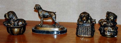 Lot 1221 - Three Bronze Dogs in Baskets; Together with a...