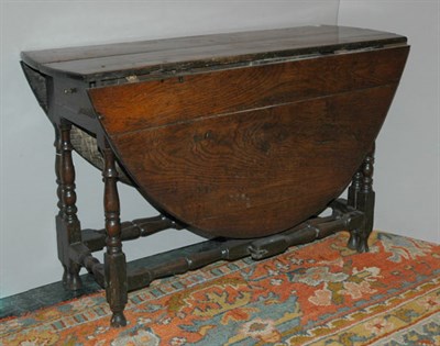 Lot 2148 - Provincial George III Oak Gate Leg Table The...