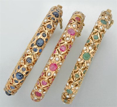 Lot 3032 - Three Indian Gold, Gem-Set and Split Pearl Bangles