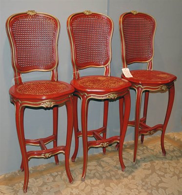 Lot 4454 - Three Red Painted and Caned Bar Stools