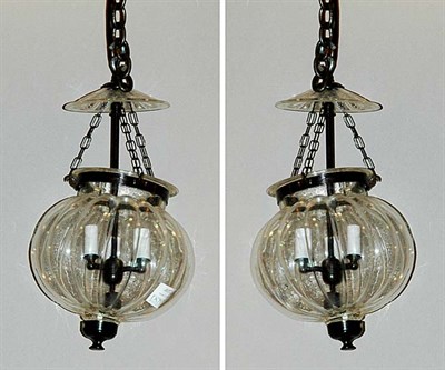 Lot 355 - Pair of Colorless Glass Globular Three-Light...