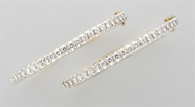 Lot 3071 - Pair of Two-Color Gold and Diamond Bangles