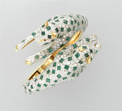 Lot 3352 - Two-Color Gold, Diamond and Emerald Panther Crossover Bangle