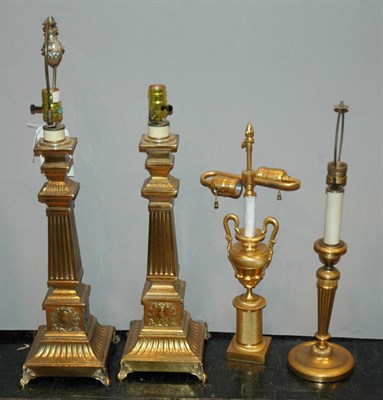 Lot 4152 - Four Neoclassical Style Gilt-Metal Lamps...