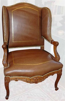 Lot 1195 - Regence Carved Beechwood Winged Armchair...