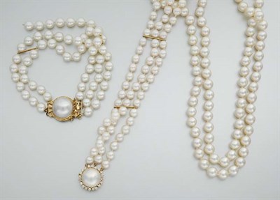 Lot 953 - Double Strand Cultured Pearl Necklace and Two Triple Strand Cultured Pearl Bracelets