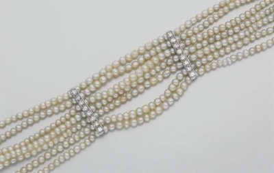 Lot 374 - Seven Strand Seed Pearl and Diamond Bracelet