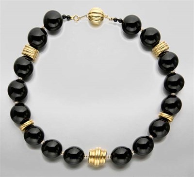 Lot 2181 - Black Onyx Bead, Gold and Diamond Necklace
