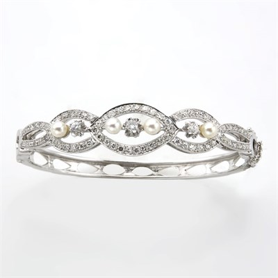 Lot 214 - White Gold, Diamond and Cultured Pearl Bangle Bracelet