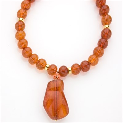 Lot 587 - Amber Bead and Yellow Metal Pendant-Necklace