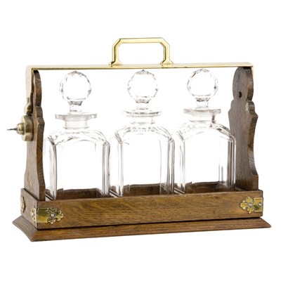 Lot 292 - Georgian Style Oak Tantalus With three glass...