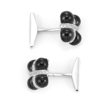 Lot 265 - Pair of White Gold, Black Onyx and Diamond Cufflinks