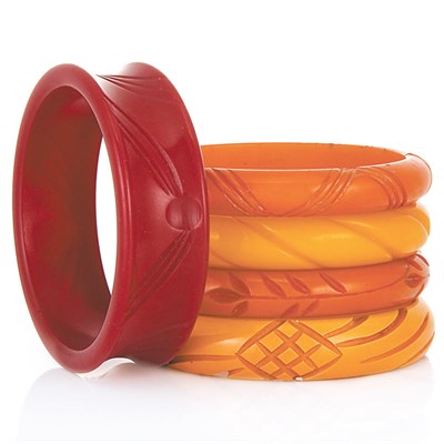 Lot 82 - Five Carved Bakelite Bangle Bracelets