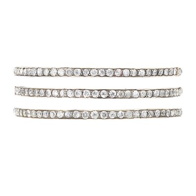 Lot 750 - Three Gold, Silver and Diamond Bangle Bracelets
