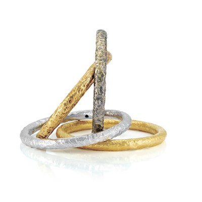 Lot 371 - Four Multicolored Hammered Gold Bangle Bracelets