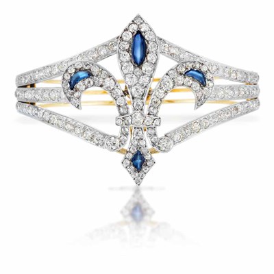 Lot 421 - Antique Rhodium-Plated Silver, Gold, Diamond and Cabochon Sapphire Fleur-de-Lys Bangle Bracelet