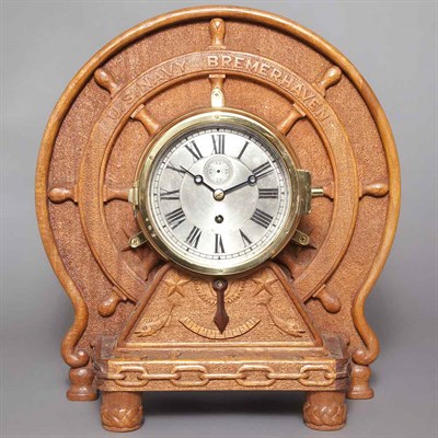Lot 287 - Bulkhead Navy Clock On a carved wood stand in...