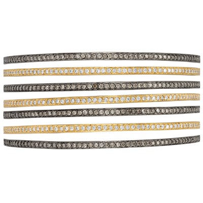 Lot 322 - Seven Gold, Blackened Gold, Diamond and Brown Diamond Bangle Bracelets
