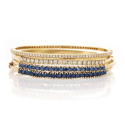 Lot 531 - Four Gold, Diamond and Sapphire Bangle Bracelets