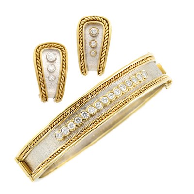 Lot 16 - Two-Color Gold and Diamond Bangle Bracelet and Pair of Earrings