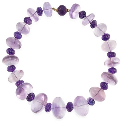 Lot 163 - Amethyst and Fluted Amethyst Bead Necklace with Gold and Carved Amethyst Bead Clasp, by Verdura