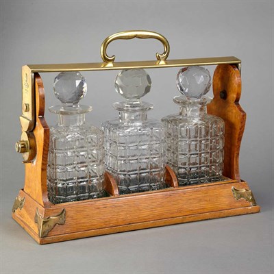 Lot 704 - Brass Mounted Wood Tantalus With three...